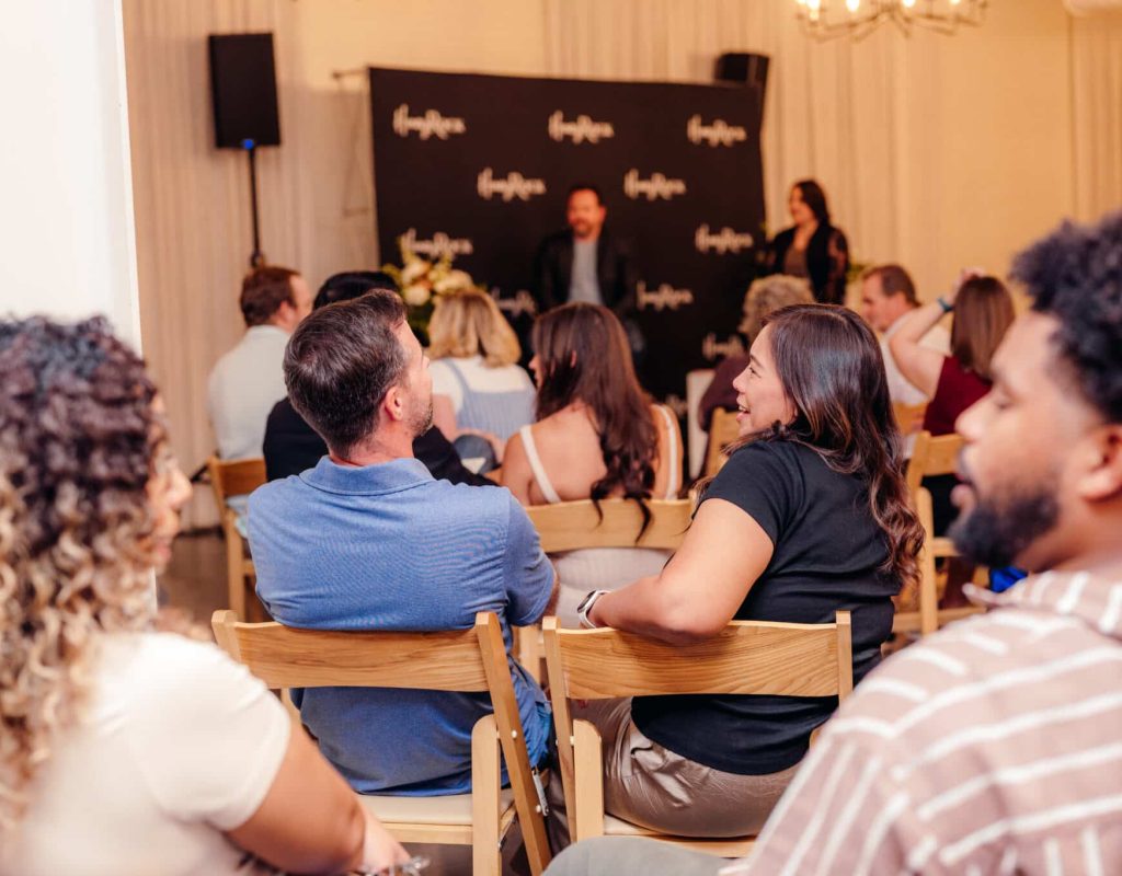 HoneyRock FOCUS Marriage Event couples discussing content from the speakers. Stage featuring Joshua and Rachael Wintermute from Quiet Winters, LLC - Design + Life Coaching.
