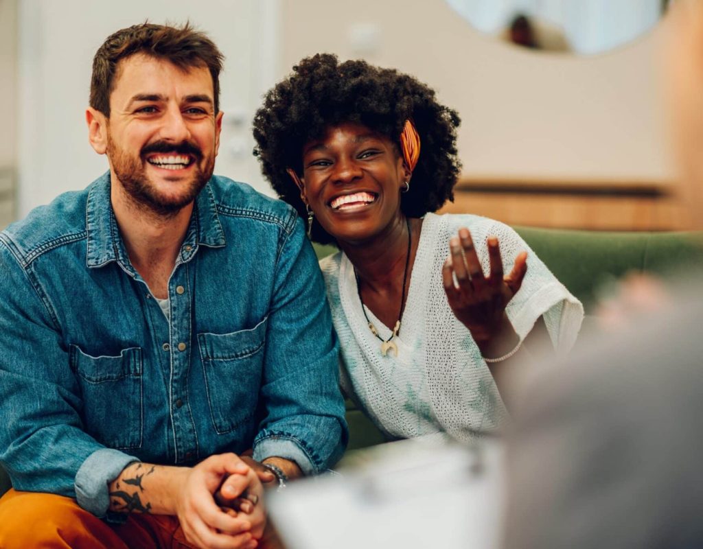 young,multiracial,couple,smiling,because,solved,conflict,at,couple,therapy